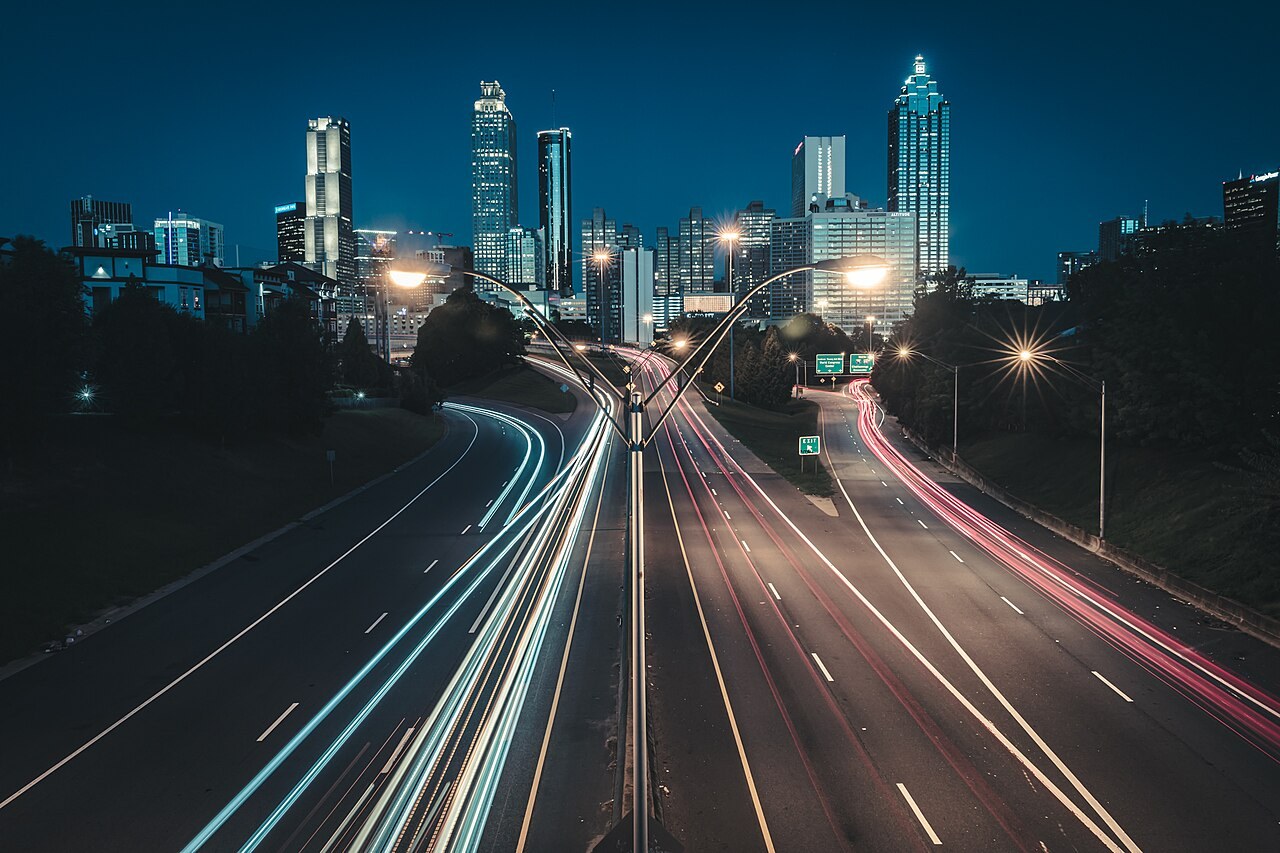 An image of the Atlanta, Georgia Skyline taken at dawn with long exposure to create light trails of the morning traffic.