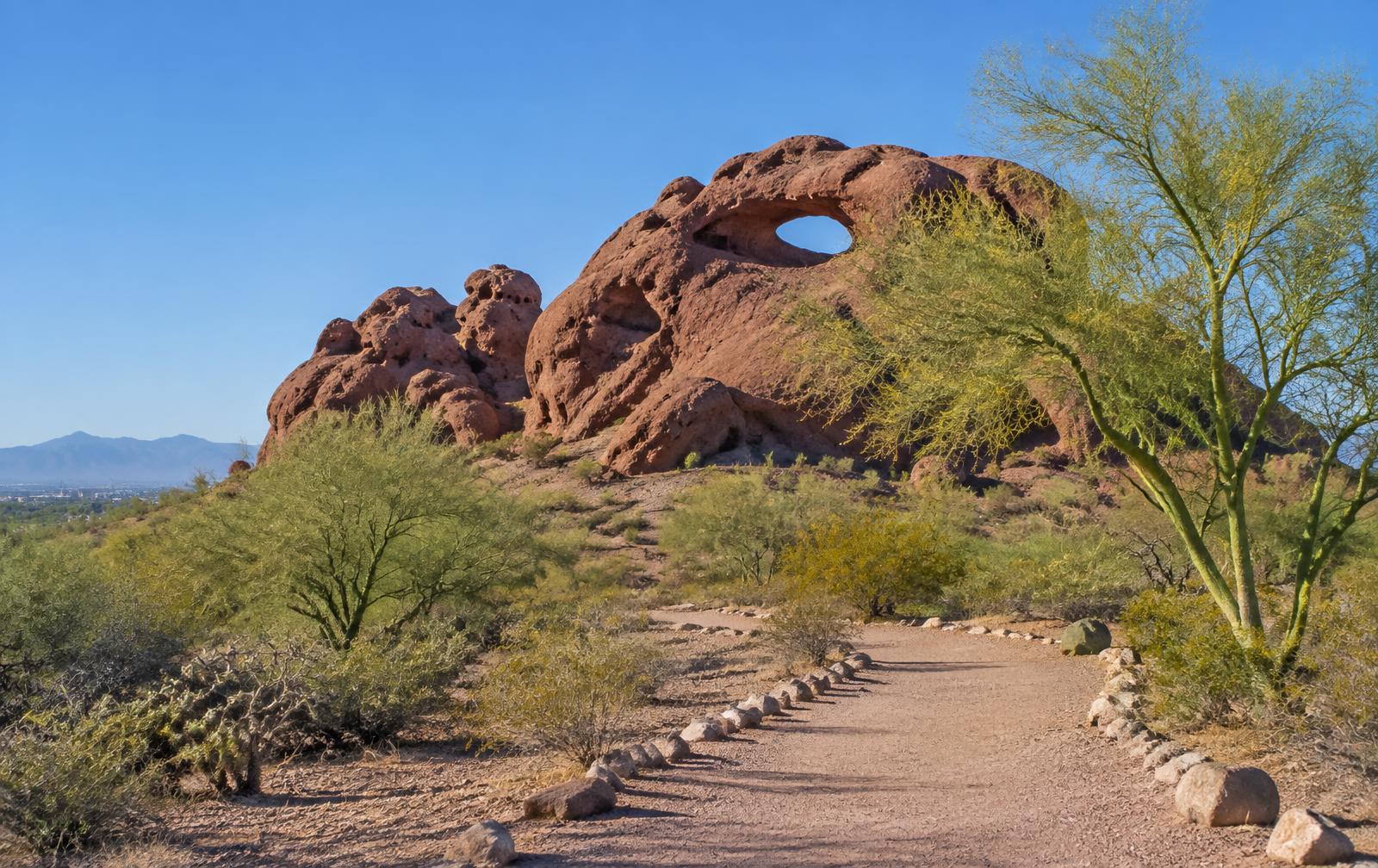Papago Park desert trail and red sandstone buttes in Phoenix, Arizona under a clear blue sky