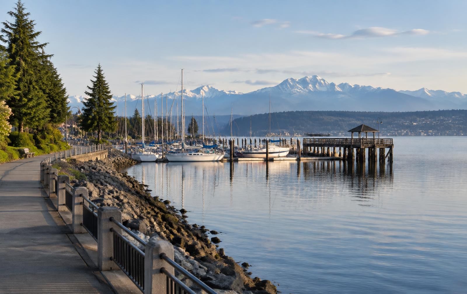 Ruston Way waterfront marina and wooden pier in Tacoma, Washington with the Olympic Mountains across Puget Sound